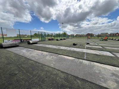 In progress image of the artificial surface being stripped off of the football field.